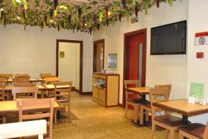 a classroom with tables and chairs and a flat screen tv at Dragon Home Inn in Cebu City
