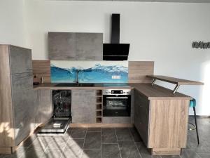 a kitchen with a stove and a counter top at Pension Hanisch in Buch +7 photos
