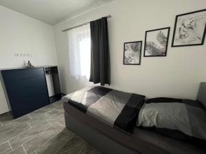 a bedroom with a bed and pictures on the wall at Pension Hanisch in Buch