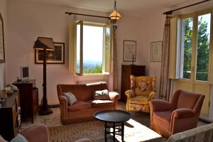 a living room with furniture and a large window at Family Friendly Villa Liberty With Pool - Happy Rentals in Aulla