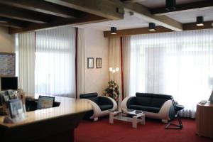 a living room with two chairs and a table at Sonnleiten-Rupert in Bad Griesbach