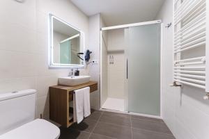 a white bathroom with a sink and a shower at PENSIÓN CASA ELENA *** in Arzúa