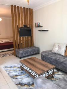 a living room with a couch and a coffee table at Olivia Apartment at Ölüdeniz - Central in Oludeniz