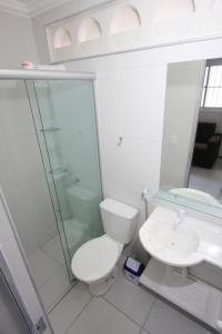 a bathroom with a toilet and a shower and a sink at Residencial Santa Lucia in Fortaleza