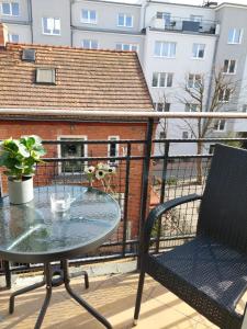 a patio table and a chair on a balcony at JM Sopot Apartament Monte in Sopot +10 photos