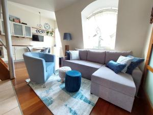 a living room with a couch and a chair at JM Sopot Apartament Monte in Sopot