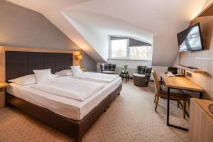 Postel nebo postele na pokoji v ubytování Göbel's Sophien Hotel