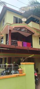 a house with clothes hanging on the balcony of it at Christa Homestay, AC,near A.J. Hospital, Mangalore in Mangalore