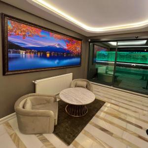 a living room with a table and a large window at MQ Hotel Suites in Arnavutköy