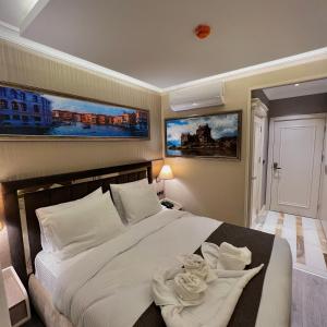 A bed or beds in a room at MQ Hotel