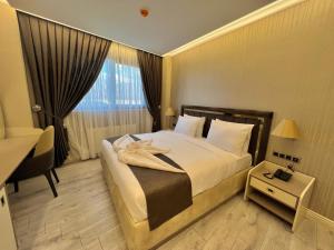 A bed or beds in a room at MQ Hotel