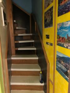a set of stairs in a room with paintings on the walls at Affittacamere La Baia Di Lerici in Lerici