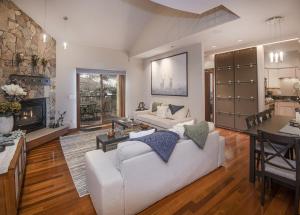 a living room with a white couch and a fireplace at Vail Point 7 townhouse in Vail