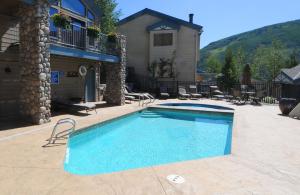 a swimming pool in front of a house at Vail Point 7 townhouse in Vail