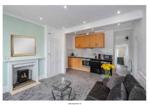 a living room with a couch and a fireplace at The Park Apartment in Haywards Heath