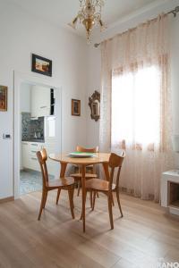 The VIEW Apartment, MURANO island في مورانو: غرفة طعام مع طاولة وكراسي خشبية