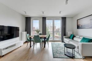 a living room with a couch and a table at Aura 40 City Center by Downtown Apartments in Gdańsk +27 photos