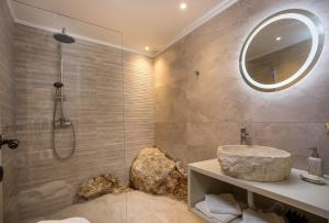 a bathroom with a sink and a shower at Heritage Luxury Suites in Líndos