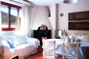 a living room with a white couch and a table at Blanca Martín in Trevélez