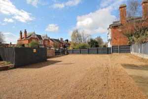 an empty driveway in a house with a fence at Hamilton in Lincoln