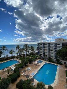 a view of the pool and the ocean from the balcony of a resort at Marbella Skol in Marbella