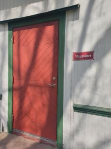 a red door on the side of a building at Magasinet in Torsåker