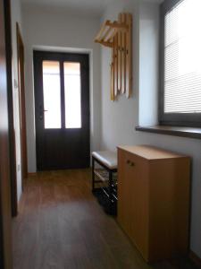 a room with a door and a chair and a table at Apartmán u Hovorků in Borová Lada