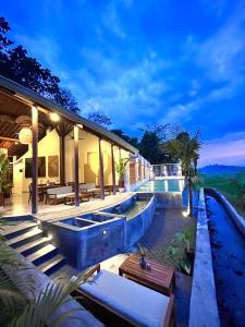 a villa with a swimming pool at night at boutique villa jogja senang in Yogyakarta