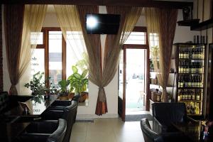 a bar with chairs and a television in a room at Apartmany BB in Karviná