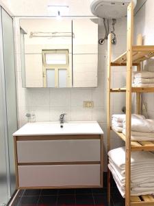 a bathroom with a sink and a mirror at MARENAXOS APaRTMENT in Giardini Naxos