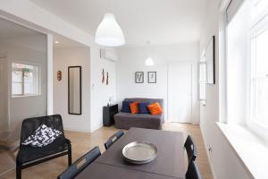 a living room with a table and chairs and a couch at FLH Marquês Charming Flats in Lisbon