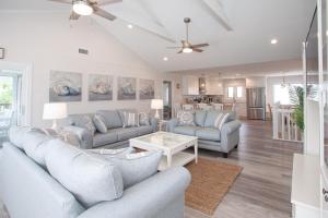 a living room with two couches and a table at Lazy Day-Z in Virginia Beach