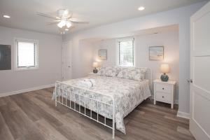 a white bedroom with a bed and a ceiling fan at Lazy Day-Z in Virginia Beach