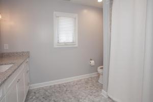 a white bathroom with a toilet and a window at Lazy Day-Z in Virginia Beach