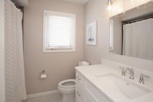 a bathroom with a sink and a toilet and a window at Lazy Day-Z in Virginia Beach