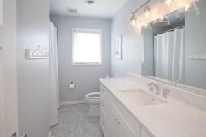 a white bathroom with a sink and a toilet at Lazy Day-Z in Virginia Beach