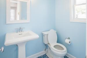 a bathroom with a white toilet and a sink at Lazy Day-Z in Virginia Beach