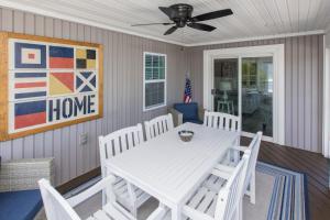 a dining room with a white table and chairs at Lazy Day-Z in Virginia Beach