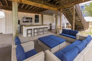 a patio with blue cushioned chairs and a kitchen at Lazy Day-Z in Virginia Beach