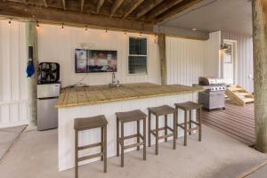 a kitchen with a counter and stools in a garage at Lazy Day-Z in Virginia Beach