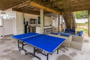 a ping pong table in the middle of a patio at Lazy Day-Z in Virginia Beach