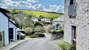 an empty street in a small village with houses at Shippon End - Barn conversion with character and charm in Dittisham