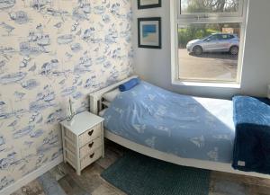 a small bedroom with a bed and a window at So Tranquil in Charlestown