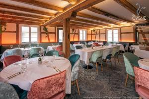 a dining room with white tables and chairs at Hôtel Restaurant Au Cygne in Eschau +23 photos