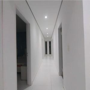 an empty hallway with white walls and white floors at Villa San Nicolás con piscina in San Bernardino