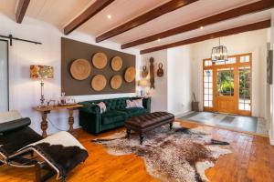 a living room with a green couch and a table at Ganzvlei Manor in Knysna
