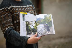 a person holding a book in their hand at Suite - Sweet MayLeen in Merano