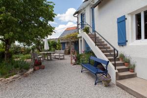 a blue bench sitting outside of a house at Apartment Fleur de Lys Bleue in Soudaine-Lavinadière