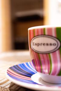 a coffee cup sitting on a plate on a table at Casavacanze Antonio in Leuca
