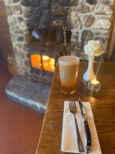 a table with a fork and a cup of coffee and a candle at The Trooper Inn in Petersfield +4 photos